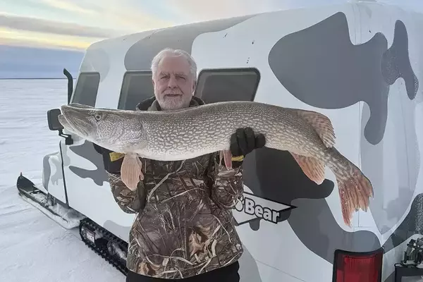 Epic Winter Catch: Angler Lands Giant Pike Through Icy Depths