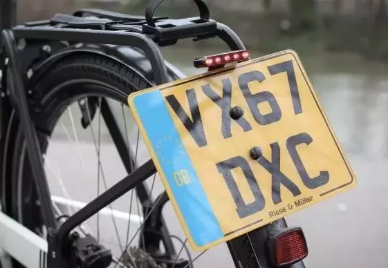 Cycling Debates: Road Taxes, Number Plates, and Pro Rider Memorabilia