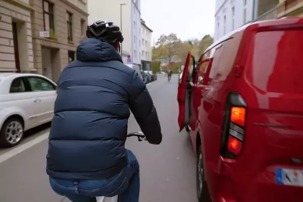 Cyclist's Dooring Incident Highlights Driver Responsibility Over Rider Blame
