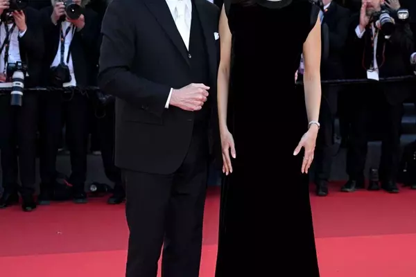 John Travolta's Cannes Style Evolution: From Acting Icon to Beret-Clad Director